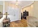 Inviting foyer featuring wood floors, a double-door entry, and neutral wall colors at 5245 Nw 21St Loop, Ocala, FL 34482