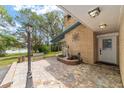 Charming single story home showcasing a brick exterior, small courtyard, and a view of the lake at 1179 Se 170Th Ct, Silver Springs, FL 34488