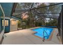 A screened-in in-ground pool features tiled edges and clear water for a refreshing outdoor space at 1179 Se 170Th Ct, Silver Springs, FL 34488