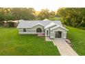 Well-maintained single-story home on a green lawn featuring a clean facade and an attached garage at 14171 Sw 8Th Ave, Ocala, FL 34473