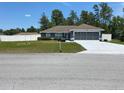 Inviting single-story home with a large front yard and a two-car garage at 15266 Sw 44Th Ter, Ocala, FL 34473