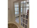 Bright office with dark wood floors, visible through glass-paned French doors from the foyer at 15266 Sw 44Th Ter, Ocala, FL 34473