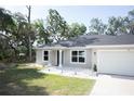 Lovely single-story home with well-manicured lawn, updated windows and stylish front door at 18 Larch Radl, Ocala, FL 34480