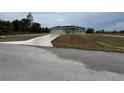 Single-story home featuring neutral-colored exterior, a wide driveway, and a neatly maintained lawn at 4424 Sw Viola Ct, Dunnellon, FL 34431