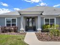 Inviting front porch with a glass-paned door, manicured landscaping, and classic architectural details at 4806 Nw 8Th Ter, Ocala, FL 34475