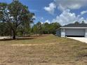 A home with a two car garage and large front lawn at 4928 Sw Evergreen Ct, Dunnellon, FL 34431