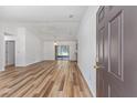Bright living room with wood flooring, ceiling fan, sliding glass doors, and plenty of natural light at 6057 Se 39Th Ave, Ocala, FL 34480