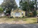 Charming yellow home with white trim, a classic bungalow-style facade, and a cozy garden area at 621 Ne 20Th St, Ocala, FL 34470