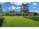Spacious front yard of a single-story home with well-maintained lawn, mature trees, and pleasant curb appeal at 811 Se 49Th Ave, Ocala, FL 34471