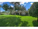 Attractive single-story home with a well-manicured front lawn, mature trees, and neatly trimmed bushes at 811 Se 49Th Ave, Ocala, FL 34471