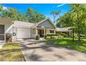 This home has a manicured lawn, cozy front porch, and attached garage, all under a sunny blue sky at 8747 Sw 98Th Street Rd # F, Ocala, FL 34481