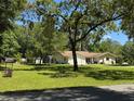 Spacious home with a large yard, mature trees, and a convenient two-car garage at 8951 Sw 202Nd Avenue Rd, Dunnellon, FL 34431