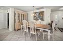 Elegant dining area featuring a stylish table set, a decorative china cabinet, and tasteful wall art at 9452 Sw 93Rd Loop, Ocala, FL 34481