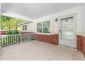 Inviting covered porch with brick accents, white railing, and views of the landscaped front yard at 9855 Sw 85Th Terrace Rd # A, Ocala, FL 34481