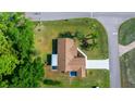 Aerial view of cozy home showing roof, driveway and yard with mature trees surrounding the property at 10668 Sw 85Th Ter, Ocala, FL 34481