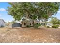 Quaint home with front-yard trees and a black steel fence at 1114 Hickory Rd, Ocala, FL 34472