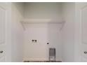 Bright laundry room with storage shelf and convenient hookups at 1598 Sw 152Nd Ct, Ocala, FL 34481