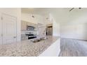 Well-equipped kitchen with granite counters and stainless steel appliances at 1610 Sw 152Nd Ct, Ocala, FL 34481