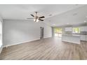 Bright and airy living room with hard floors and a view of the kitchen at 2114 W Magenta Dr, Citrus Springs, FL 34434