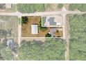 Aerial view showing the home's lot, outbuildings, and surrounding landscape at 3112 Se 140Th Ln, Summerfield, FL 34491