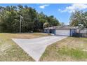 Long driveway leading to a well-kept single-story home with mature trees at 3112 Se 140Th Ln, Summerfield, FL 34491