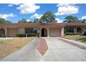 Inviting home with a classic facade, lush landscaping, and an attached garage providing convenient parking at 3449 Sw 19Th St, Ocala, FL 34474