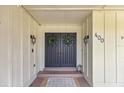 Elegant double front doors are adorned with wreaths, creating a welcoming entrance to the home at 400 Se 45Th Ter, Ocala, FL 34471