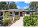 Inviting home featuring a walkway to the front door and lovely landscaping at 408 Etheredge St, Bushnell, FL 33513