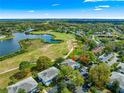 Aerial view showcasing the community with serene lake, lush golf course, and charming residential buildings at 450 Fairways Cir # A101, Ocala, FL 34472