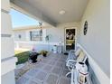 Inviting front porch with decorative seating, welcome decor and tiled flooring at 6239 Sw 98Th Loop, Ocala, FL 34476