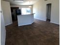 The living room and kitchen features neutral walls and tile flooring at 77 Dogwood Drive Pass, Ocala, FL 34472