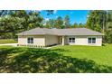 Inviting single-story home featuring a well-manicured lawn and fresh landscaping at 8498 Sw 129Th Terrace Rd, Dunnellon, FL 34432