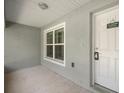 Inviting front porch of a home with a white door and a clear 'No Soliciting' sign at 9835 Sw 207Th Cir, Dunnellon, FL 34431