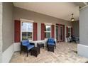 Charming front porch with brick floor and stylish outdoor seating area at 10082 Sw 82Nd Place Rd, Ocala, FL 34481