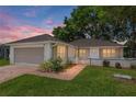 Charming home with brick paved driveway, lush lawn, and manicured landscaping at 11146 Sw 68Th Ct, Ocala, FL 34476
