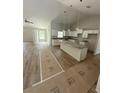 Spacious kitchen with white cabinets, granite countertops, and center island before completion at 12720 Sw 73Rd Street, Ocala, FL 34481