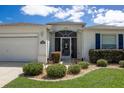 Well-kept single-story home featuring a screened front entry and manicured landscaping at 15691 Sw 11Th Court Rd, Ocala, FL 34473