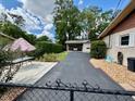 View of the home's exterior and driveway with an outdoor seating area and mature landscaping at 4145 Se 3Rd St, Ocala, FL 34471