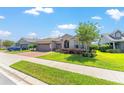 Charming single-story home boasts a three-car garage, arched entryway, and manicured lawn at 4379 Nw 56Th Ct, Ocala, FL 34482