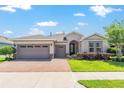 Charming single-story home boasts a three-car garage, arched entryway, and beautifully landscaped front yard at 4379 Nw 56Th Ct, Ocala, FL 34482