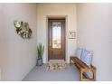 Inviting front porch features a decorative plant, bronze wall art, bench, and an impressive front door at 4379 Nw 56Th Ct, Ocala, FL 34482