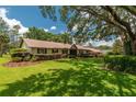 Inviting single-story home with lush front lawn and mature landscaping at 4530 Nw 78Th Ave, Ocala, FL 34482