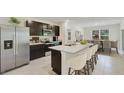Beautiful kitchen featuring stainless steel appliances, a central island with seating, and an adjacent dining area at 4698 Sw 88Th Ln, Ocala, FL 34476