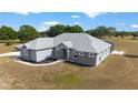 Low aerial view showing the rear of the home and surrounding acreage at 5489 Nantahala Ln, Lady Lake, FL 32159