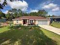 Attractive single-story home with a well-manicured lawn and a convenient two-car garage at 7488 Sw 204Th Ave, Dunnellon, FL 34431