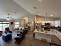 Open-concept living space with modern kitchen, granite island, and stainless steel appliances at 7488 Sw 204Th Ave, Dunnellon, FL 34431
