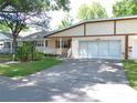 Charming single-story home featuring a well-manicured lawn and a two-car garage at 8653 Sw 95Th Ln # F, Ocala, FL 34481