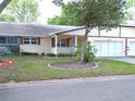 Charming single-story home featuring a well-manicured lawn and a two-car garage at 8653 Sw 95Th Ln # F, Ocala, FL 34481