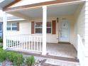 Inviting front porch with white railings and ample space for outdoor seating at 8653 Sw 95Th Ln # F, Ocala, FL 34481
