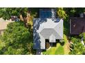Aerial view of a well maintained house with a screened-in pool and lush landscaping at 9129 Sw 193Rd Cir, Dunnellon, FL 34432